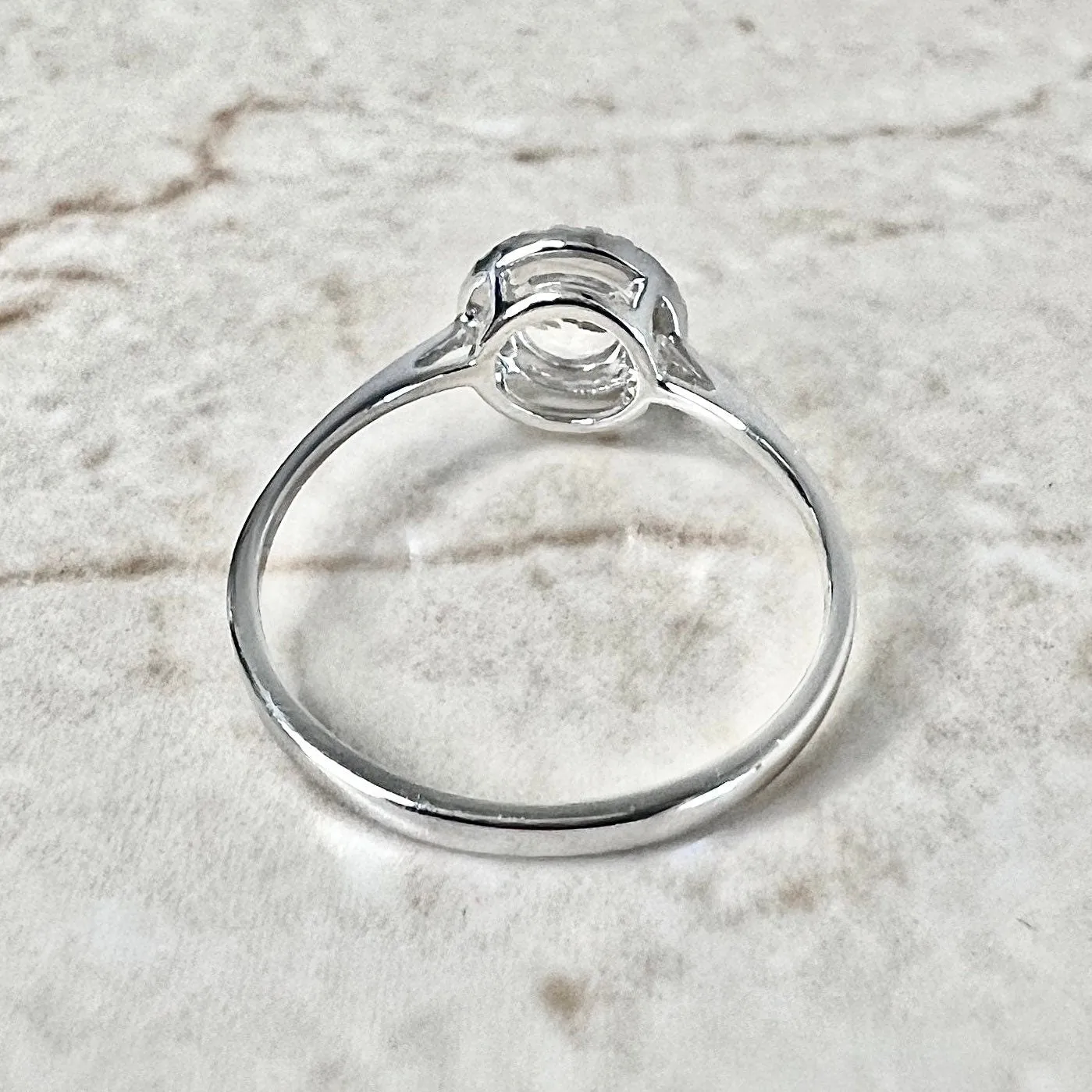 14 Karat White Gold April Birthstone Round White Topaz & Diamond Halo Ring
