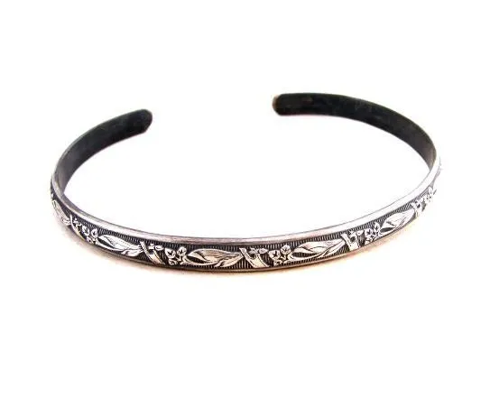 Sterling silver bracelet with floral design and patina