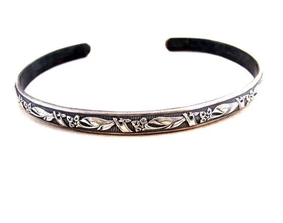 Sterling silver bracelet with floral design and patina